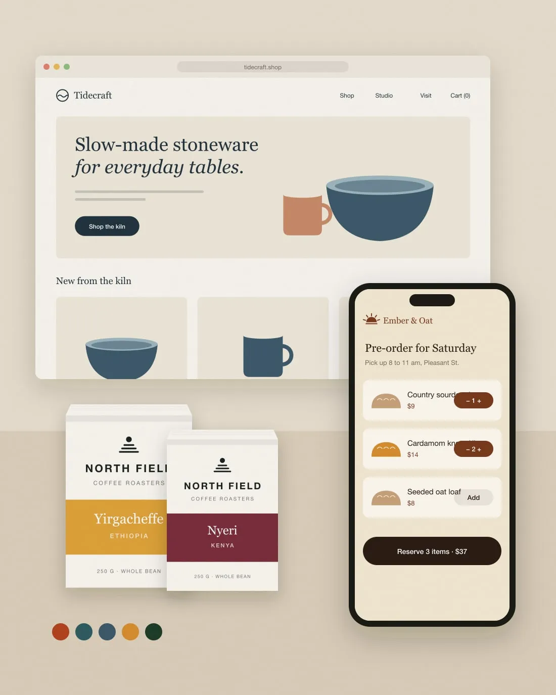 A studio desk with a Tidecraft shop open in a browser, two North Field coffee bags and the Ember & Oat pre-order page on a phone
